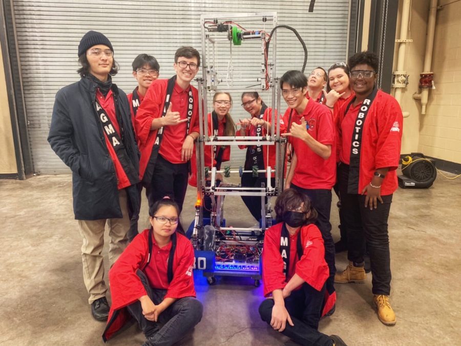 After a week in Duluth, MN and two days of competition, Team Magma’s final ranking at the Lake Superior Regionals is 52/62. Standing beside their bot ‘Opportunity’ are (standing) Brendan Nagelmann (12) Zi Tao Li (9), Noah Eckfeldt(12), Regina Lee (10), Angelina Blen (11), Tyler Leong (12), Wayland Kwock (mentor), Michelle Judd (11), Mija Wheeler(10th) and (sitting) Carmen Lam (11) and Spencer Wells (12). Photo by Sharlene Whang 2019. 