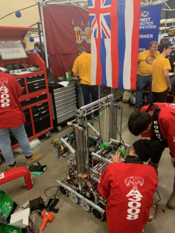 The robotics build team works on their newly named robot Opportunity. Today, March 7, is practice day before the preliminary matches tomorrow. Pictured are, from left to right, Mija Wheeler (10), Tyler Leong (12), and Zi Tao Li (9). 