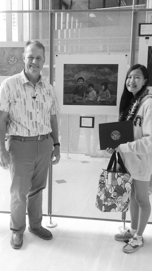 Edward Case, the U.S. Representative for Hawaiis 1st congressional district, stands beside Clara Wu (11) and her artwork entitled Bubblegum Chums which won a top art prize on May 4. Photo courtesy of James Mosher. 