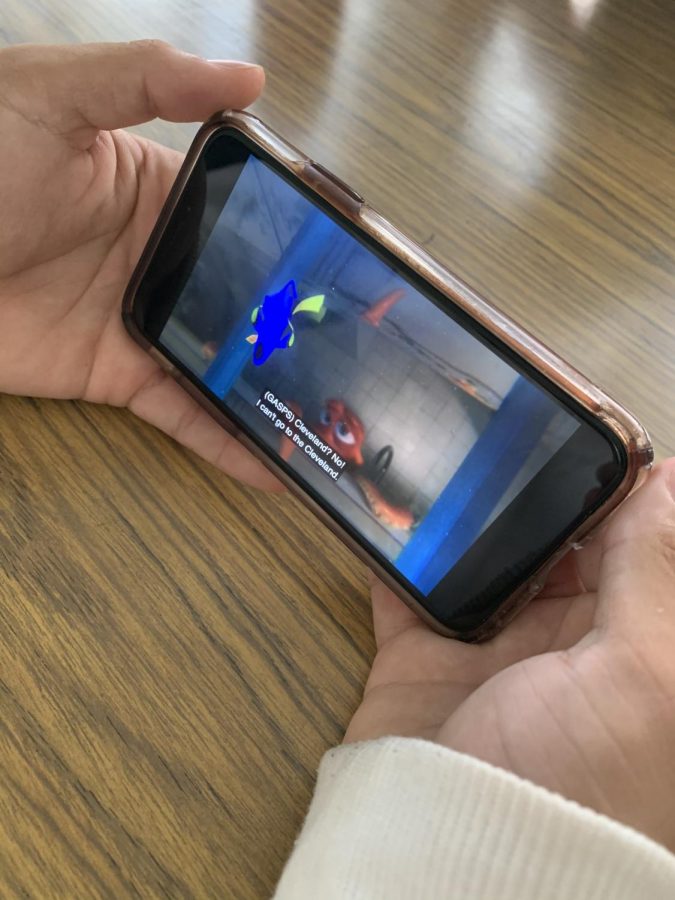 A student watches Finding Dori on his iPhone through his Disney Plus subscription. Disney+ is a subscription video on-demand streaming service owned and operated by the Direct-to-Consumer & International division of The Walt Disney Company that allows users to watch content on their computers and mobile devices. Photo by Ka Leo staff 2019. 