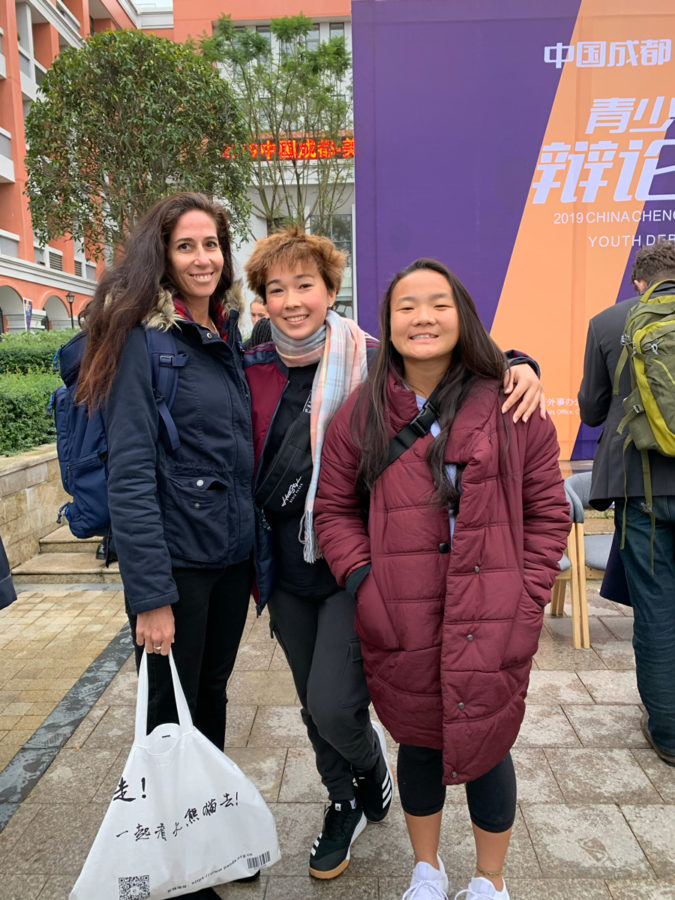 The Kalani Debate team poses in front of a local middle school, the host of the 2019 U.S. Sister Cities Youth Debate Challenge in Chengdu, China on Saturday, Nov. 23 and Sunday, Nov. 24. From the left, Kalani advisor Brooke Nasser, Reina Dreyer (12) and Pearl Lee (12). Photo by Bill Stevens 2019. 