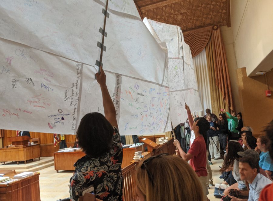Supports of Bill 40 hold up a giant scroll featuring hundreds of signatures of support. On Wednesday, Dec. 4 Bill 40 passed the Honolulu City Council by a vote of 7-2. Photo by Lucy Fagan 2019.