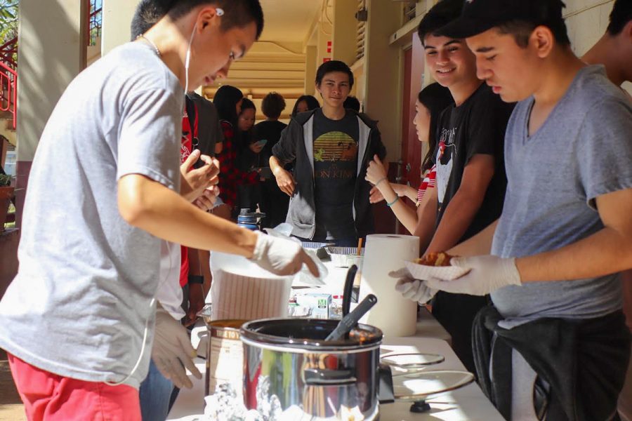 Victor Siu (11), Jose Siliezar (11), Duke Whitney (11) and Athena Huynh (11) sell nachos to raise money for Chess Club. Photo by Annyssa Troy 2020.