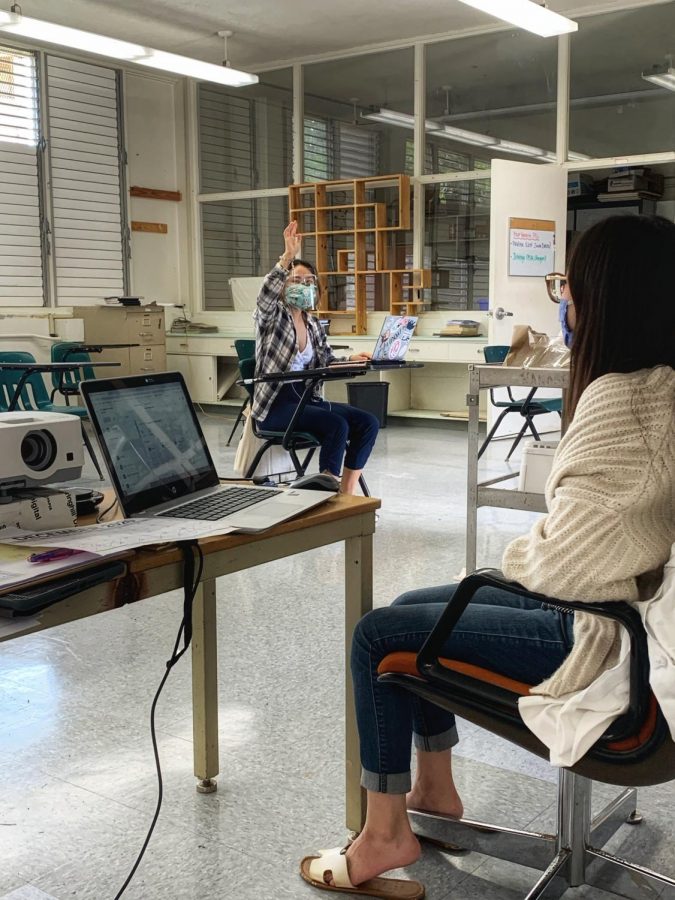 Bethlyn Tanabe (12) raises her hand in Ms. Carlyn Yoshinas marine science class. Seniors returned to campus in a hybrid schedule on Nov. 23, but many opted to stay at home and work online. Ms. Yoshinas class has seven seniors total, but usually only half of the seniors come to campus to learn in-person. Three companies—Pfizer, Moderna and AstraZeneca—have announced promising results of clinical trials on their vaccines and many believe education professionals should be the first the receive the treatment. Photo by Ka Leo staff Dec. 3, 2020.