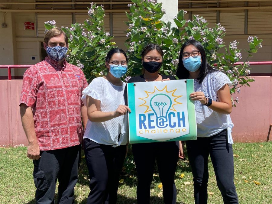 Kalani students Taylor Pimenta, Keili Takamiya, and Esther Wong stand next to their teacher, Mr. Silver, with a poster for the REACH Challenge. Photo courtesy of Taylor Pimenta. 