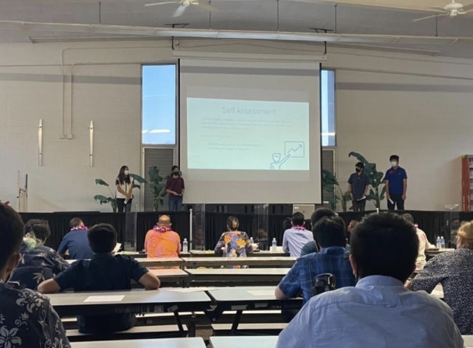 Genesis Onoyama (Middle left) presents her project with her group on Tuesday, May 17.  Along with the panelists, Imi Loa students came to present and support their fellow peers. Photo and caption by Lily Washburn. 