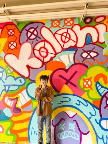 Nick Au (11) stands in front of the mural he designed and created on the hallway wall between B and C Buildings. 