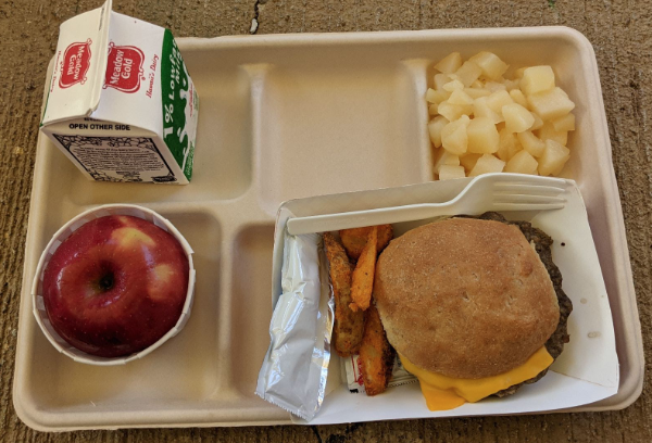 One of the more popular school lunches is the burger and fries. This meal comes with an apple, pineapple, and milk as well. Photo by Eleni Cheng. 