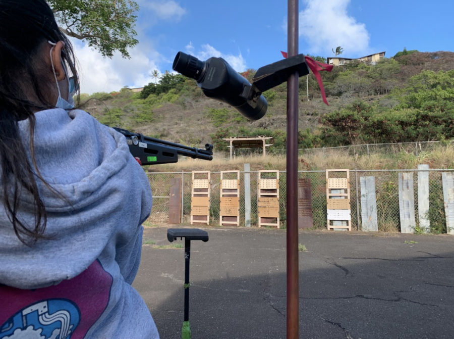 Abigayle Vendiola (11) lines up her shot for the standing position. The range -- an old, open-top parking lot shared with a shop class and the Kalani branch of Future Farmers of America -- lies adjacent to J4 and has capacity for 20 shooters. Photo and caption by Virgil Lin.