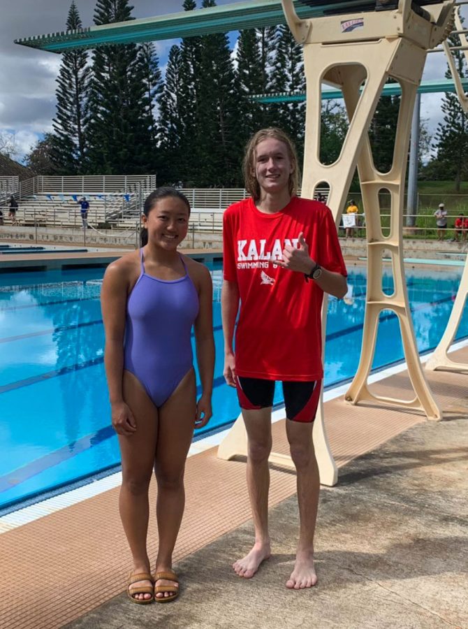 Hailey Takai (10) and Reef Robinson (12) stand beside the boards at CORP after winning OIA Championships and qualifying for states.  Photo courtesy of Takai.