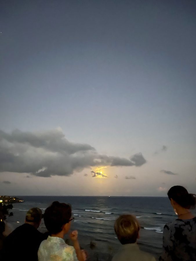 People gather around at Diamond Head lookout to view the lunar eclipse. On Sunday, May 15, the Earths shadow covered a full moon, forming a lunar eclipse, a rare sighting occurring only about three times a year, according to the Natural History Museum. 