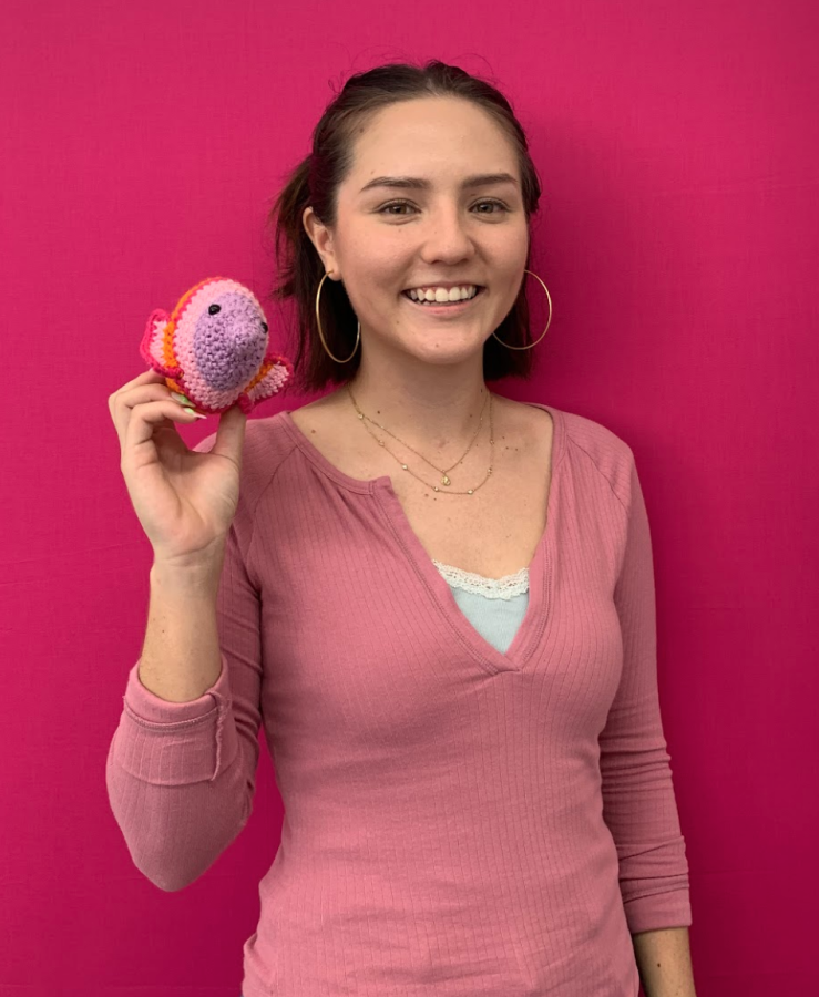 New marine science teacher Chloe Sato poses with a crochet fish she made. She has crocheted various marine animals, which she displays in her classroom for her students. 