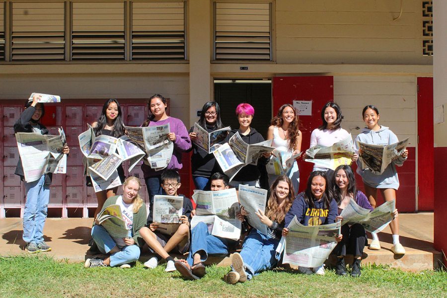 Students from News Writing years 2, 3 and 4 post in front of their classroom, C-12, with Star-Advertiser newspapers. 
Back row, left to right: Haru Gannon (10), Azriel Badon (12), Isa Taylor (12), Emily Velasco (11), CJ Endo (11), Jasmine Rossiter (12), Kylie Tanimura (11), and Ami Yamane (11).
Front row, left to right: Olivia Kulaga (10), Daniel Zheng (11), Aidan Hart (12), Lily Washburn (11), Lin Meyers (12), and Mina Kohara (12).