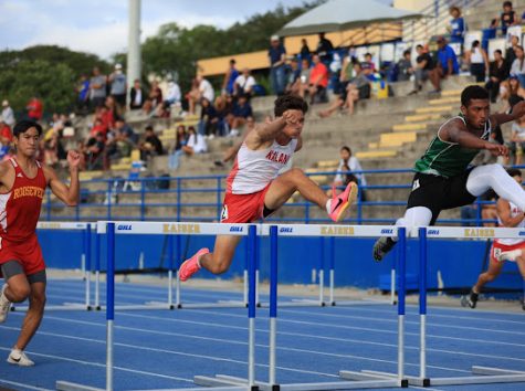 Tyler Grune (11) competes in the 110 meter hurdles at the OIA Eastern Divsional finals on Saturday, April 8. He took 4th in that event. According to his coach, Brooke Nasser, Grunes success in the hurdles is remarkable when you consider he practices on grass in trainers. 