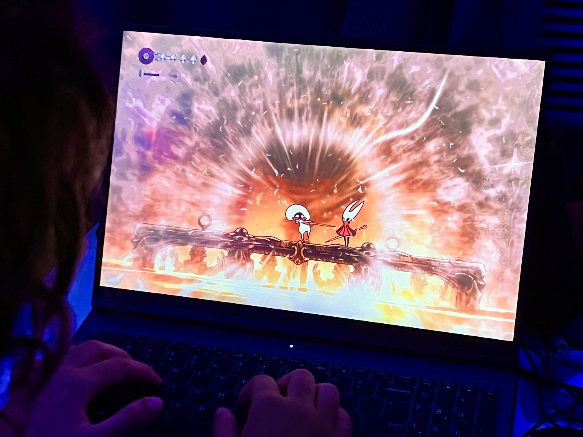 A photo of me playing Hollow Knight: Silksong on my laptop as I defeat Lace’s first fight in Deep Docks. An animation plays after hitting the finishing blow.