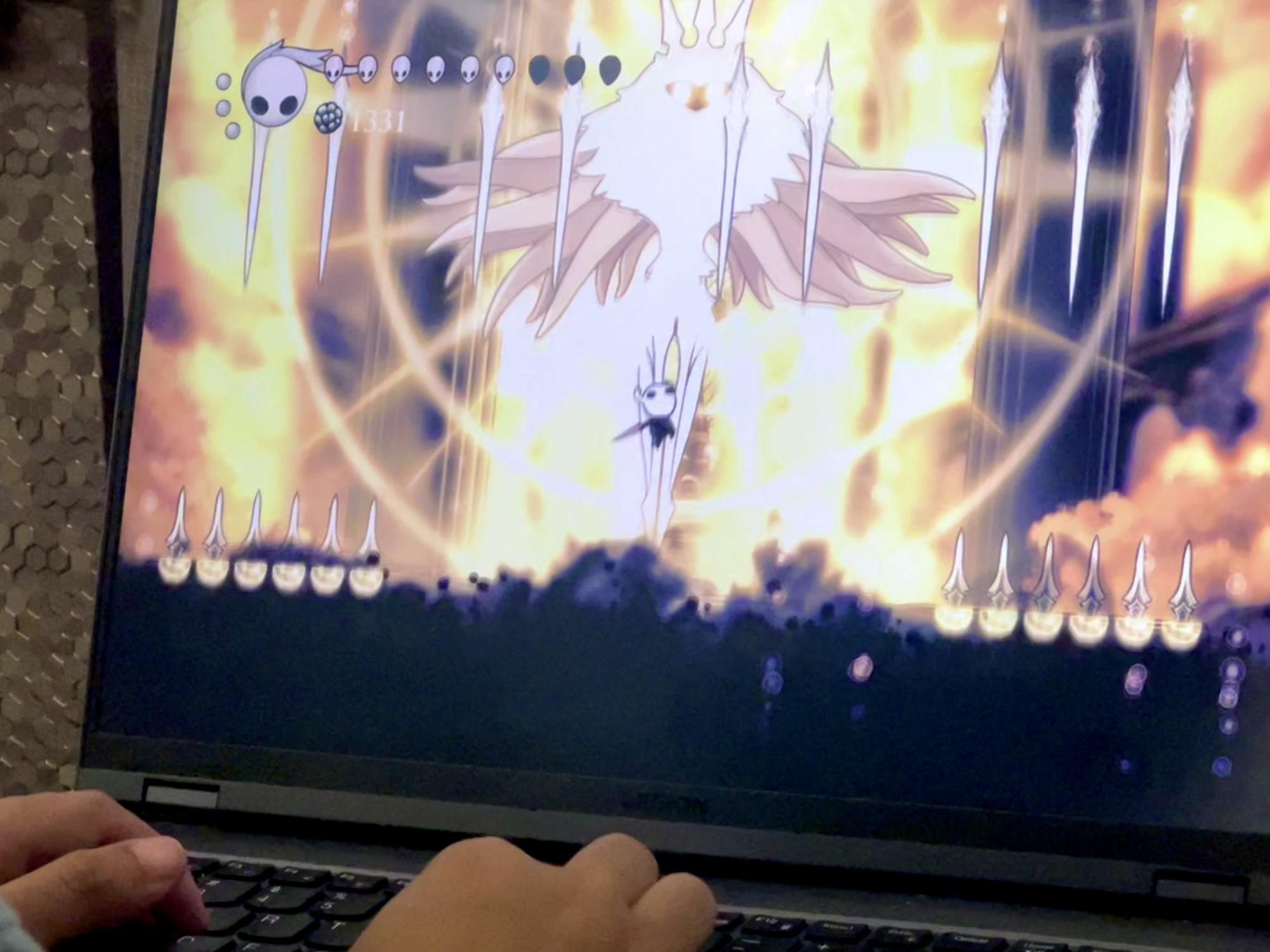 As I fight the Radiance—the final boss of Hollow Knight—void roars from below. I upslash vigorously as the Radiance summons spears, fireballs, and spikes to try and damage me.
