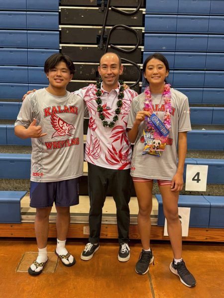 Kalani wrestling coach Racer Moody celebrates with freshmen Ashlyn Wang and Slayter Kamimura who both won their weight divisions at the Oahu Interscholastic League (OIA) JV Wrestling Championships on Saturday, Jan. 24 at Kailua High School. "Slayter Kamimura won with a last second takedown," Coach Racer says. "Match of the day for sure." The competition started on Friday, Jan. 23, with wrestlers competing throughout the day. The finals were held on Saturday.