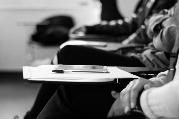 A student sits with a pen and phone resting on a blank sheet of paper, waiting to begin class. While many students feel overwhelmed by piling assignments, seniors Airi Choy and YiJia Wang maintain their focus with strict schedules and "off days" to manage heavy workloads. By prioritizing mental breaks and seeking guidance from supportive mentors, they demonstrate that academic success is as much about rejuvenation as it is about hard work.